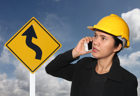 business woman call Smartphone and traffic signs on blue sky background.の写真素材
