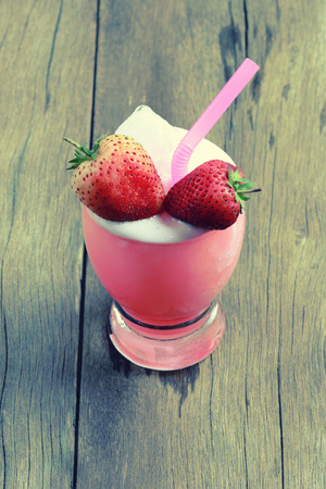 Strawberry juice in Glass on wooden table floor,Concept of fruit juice health drink.の写真素材
