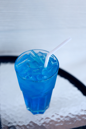 Ice Blue Hawaii in glass on table in the restaurant.の写真素材