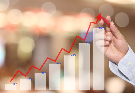 hand of Businessman point to line graph business in top,concept of business investment and profits and assessed.の写真素材
