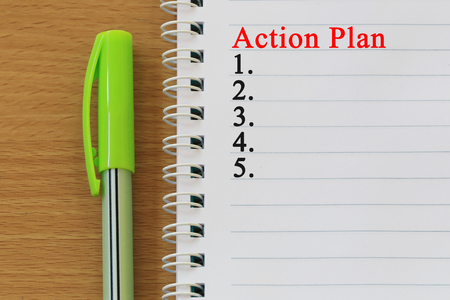 Notebooks and action plan text  are placed on a brown wooden floor and have copy space for design in your work.の写真素材