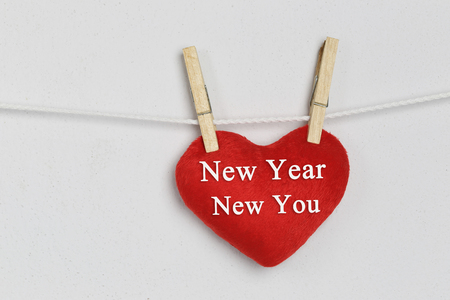 Red heart hanging on a rope and have New year New you text for design Concept in your work.の写真素材