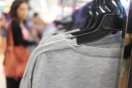 Gray T-shirt hang on the rail in the shopping mall for design in your work.の写真素材