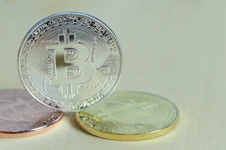 Silver bitcoin placed on wooden floor in concept of cryptocurrency idea for design in your work.の写真素材