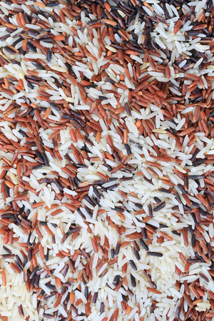 Surface of brown jasmine rice background for design in backdrop texture concept.の写真素材