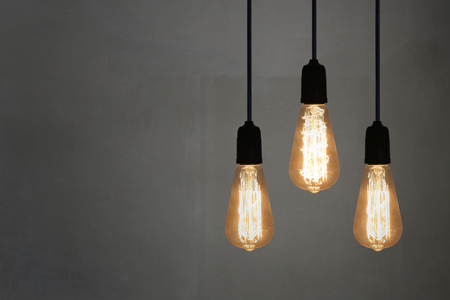 Vintage lamps in a restaurant on Gray wall background,concept of interior with lights.