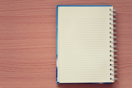 Empty book is placed on a brown wooden background and have copy space for design in your work concept.の写真素材