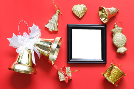 Empty black photo frame and christmas decoration on red background for design in your work concept.