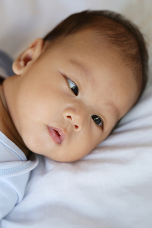 Asian Infant in a surprised on face Feeling,concept of healthy growth.の写真素材
