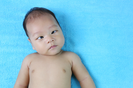 Asian Infant on a bed in face focus,concept of healthy growth.の写真素材