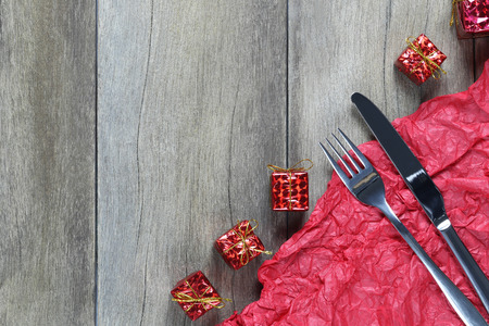 Silver fork and spoon placed near Christmas Decoration Equipment on wooden floor in celebration...