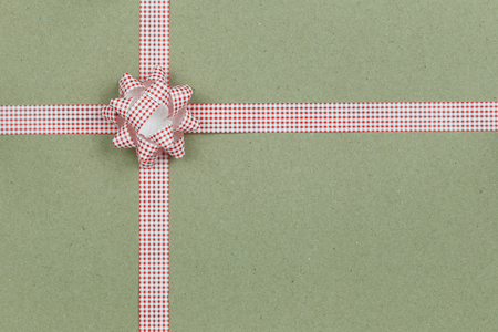 Christmas Bow and ribbon on brown paper background,Top view on gift box of Special festival.の写真素材