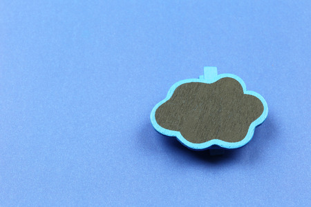 Wooden cloud shape on blue paper background and have copy space for design.の写真素材