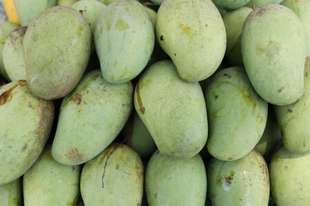 Green mango or Raw mango stacked in a fruit shop.