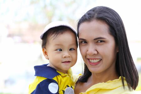 Asian mother carrying a baby,concept for mother's love for the baby in happiness.