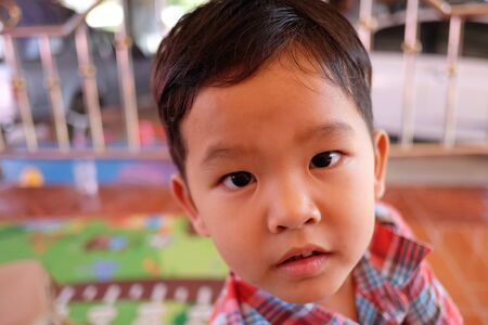 Focus on face of Asian boy is wondering,Concepts of health and growth.の写真素材