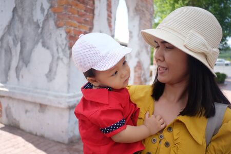 Asian mother carrying a baby,concept for mother's love for the baby in happiness.の写真素材