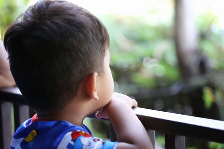 Focus on Action of Asian boy is Staring at something,Concepts of health and Learning.