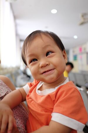 Asian boy who is smiling happily in the hospital.の写真素材