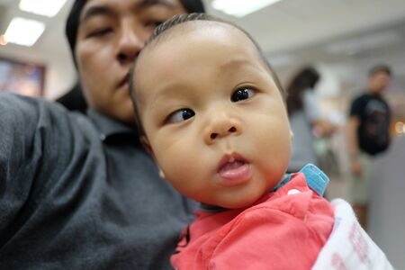 Asian boy with strabismus and dad,Portrait of infant in concept of health and medical.