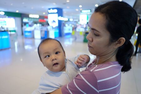 Asian boy with strabismus and mom,Portrait of infant in concept of health and medical.の写真素材