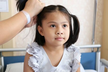 Asian child girl is styling by mom of her hair to beautiful,concept of health and cuteness.
