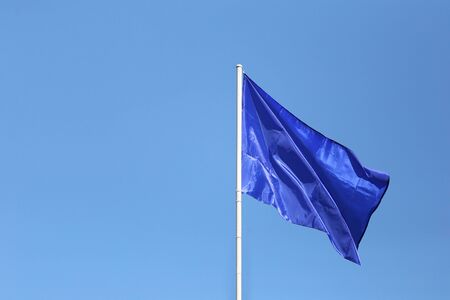 Blank blue flags in the blue sky background and have copy space for your design.の写真素材