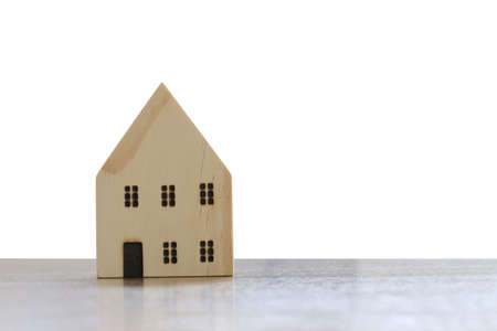 Wooden house on a wood table isolated white background and have clipping paths.の写真素材