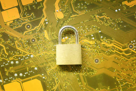 Master key or Gold Padlock on electronic motherboards background in concept of cyber security.