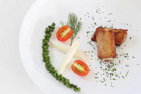 Fried Pork Ribs with pepper in white dish on wooden floor,Healthy Thai food menu.の写真素材