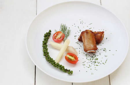 Fried Pork Ribs with pepper in white dish on wooden floor,Healthy Thai food menu.の写真素材