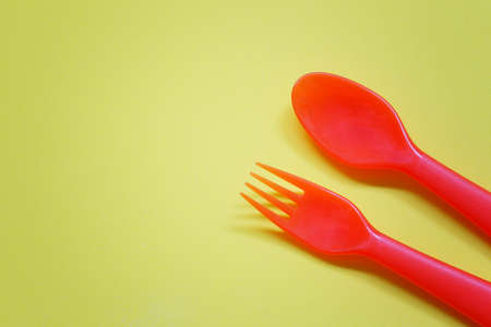 Plastic spoon and fork placed on a bright background and have copy space for design in your work.の写真素材