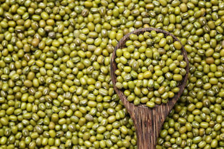 Fresh seed green beans in wooden spoon for design in your work.