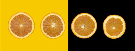 Orange slice isolated on yellow and black background for design in your work concept.の写真素材
