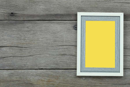 Empty Vintage photo frame on old wood background and have copy space for design in your work.
