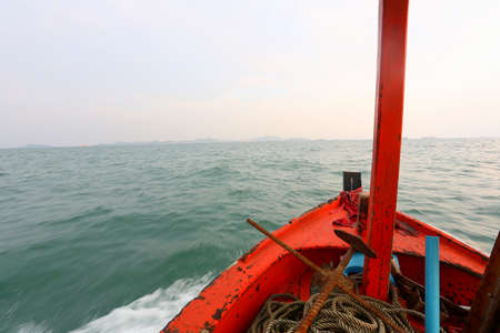 Prow of a small boat was rushing out into the vast sea in front,travel and adventure concept.