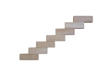 Wooden toy are arranged in the shape of a ladder isolated on white background and have clipping...