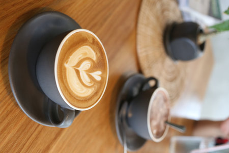 Coffee mugs placed on a table in a coffee shop, Latte art in a white glass in a cafe for design in your work concept.の写真素材