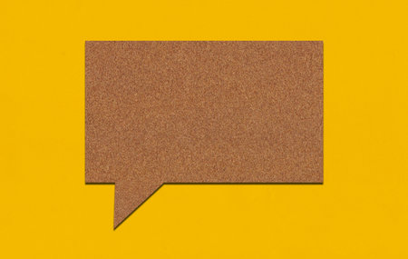 Brown paper speech bubble on yellow paper background. Paper blank of text box with copy space for...