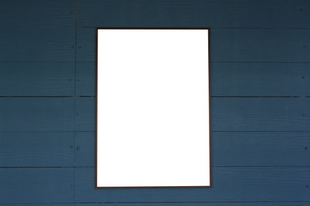 Empty picture frames on a dark wooden blue wall for design and ideas in your work.