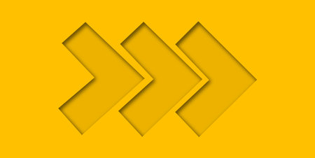 Yellow paper cut into holes arrow shape are overlaid with light and shadow and have copy space.