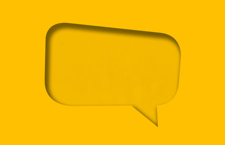 Yellow paper cut into holes speech bubble shape are overlaid with light and shadow and have copy...