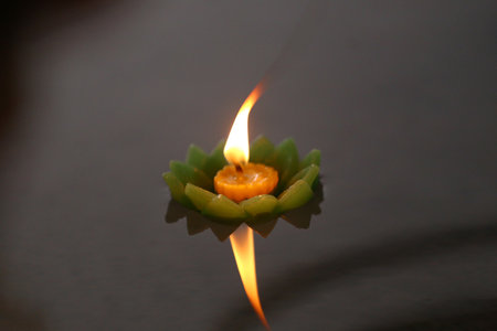 Candles of Krathong with flames floating on the water, A Buddhist ritual that is believed to remove bad things from life when floating candles.の写真素材