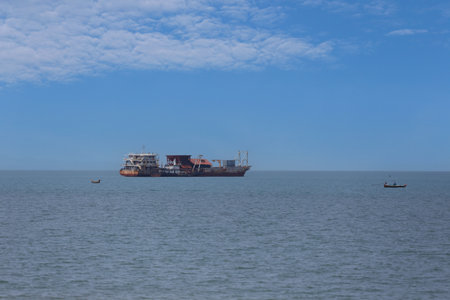 Sand suction boat moored on the sea shore of Jomtien Beach of Pattaya City and Boats will suck up sand and fill the beach to increase the beach area.の写真素材