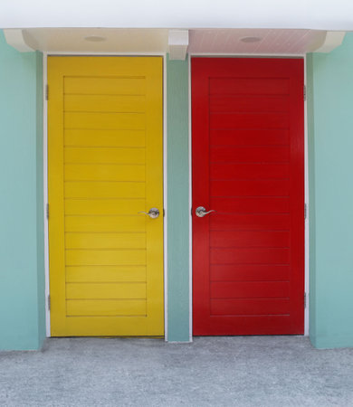 Yellow and red room door mounted on green wall, use for your work design.