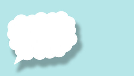 Empty white cloud paper speech bubble shape against light blue background for design in your work business concept.の写真素材