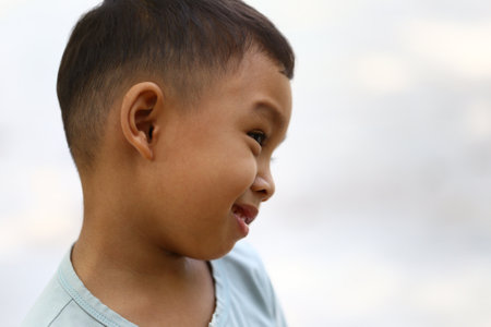 A joyful young boy displaying a playful expression brings a sense of innocence and happiness. This portrait captures the essence of childhood and carefree moments.の写真素材
