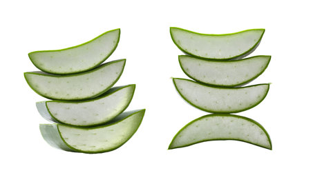 Stacked slices of fresh aloe vera showcase their vibrant green edges and succulent interior and have clipping paths. Ideal for health and beauty applications, emphasizing natural freshness and organic quality.の写真素材