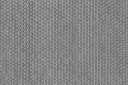 This textured gray plastic background features a sleek and elegant design, perfect for various creative projects, ranging from fashion to interior decor.の写真素材