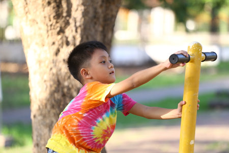 A cheerful child engages in outdoor exercise, showcasing energetic movement and a playful spirit. Bright colors reflect a lively atmosphere.の写真素材